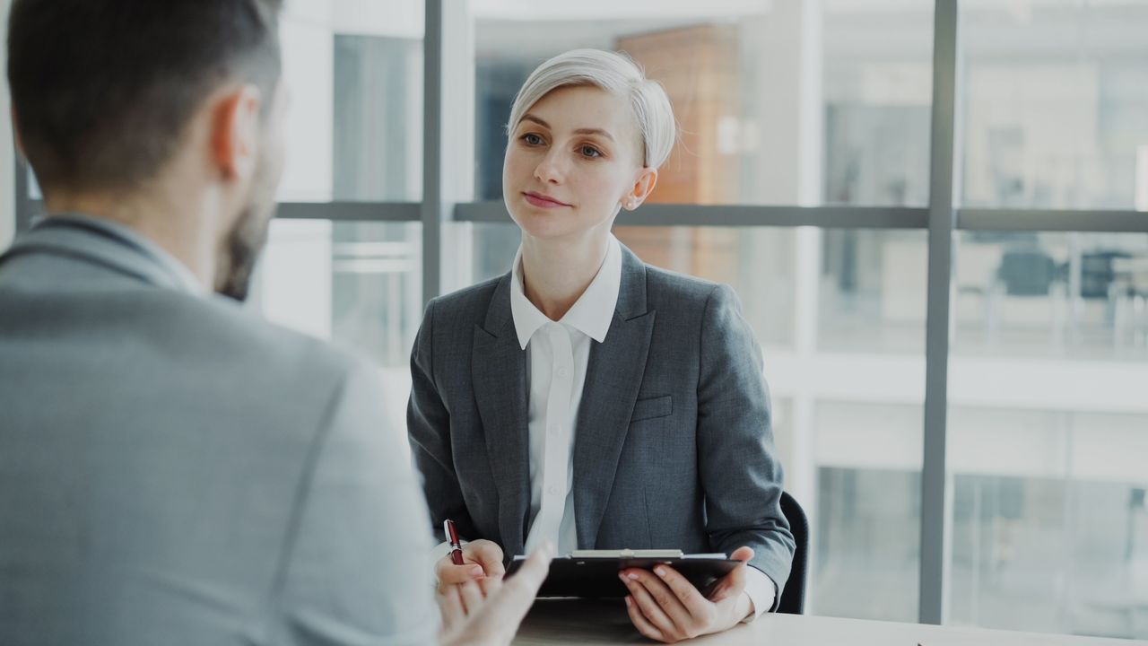 Business meeting featuring two professionals in a modern office setting.